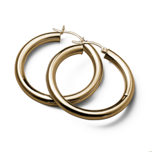 Load image into Gallery viewer, Elegant 14K yellow gold hoop earrings, 40mm in diameter with a 5mm tube width, offering a blend of delicate beauty and quality, suitable for everyday wear or special occasions.
