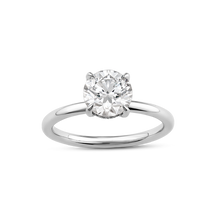 Load image into Gallery viewer, Elegant solitaire in 18K white gold, featuring a round brilliant laboratory diamond in an eagle claw setting, surrounded by a hidden halo of 16 small diamonds totaling 0.08tcw, blending classic and contemporary styles.
