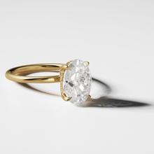 Load image into Gallery viewer, Elegant engagement ring in 18K yellow gold, featuring a 2ct Moissanite Oval with eagle claw setting, and a hidden halo of 0.05ct in 14 small diamonds, offering a modern look with exceptional sparkle.
