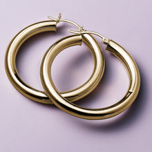 Load image into Gallery viewer, Elegant 14K yellow gold hoop earrings, 40mm in diameter with a 5mm tube width, offering a blend of delicate beauty and quality, suitable for everyday wear or special occasions.
