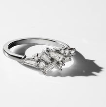 Load image into Gallery viewer,  This 18K white gold ring features a unique arrangement of baguette and round brilliant diamonds, totaling 0.55ct for the baguettes and 0.11ct for the seven diamonds, set in a claw setting, offering an exquisite and captivating design.
