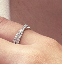 Load image into Gallery viewer, Unique band in platinum, weighing approximately 4.3gr, featuring an almost Mobius-twisting design with a crossover wrap adorned with 1.13tcw of round diamonds pavé set.
