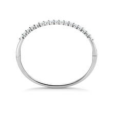 Load image into Gallery viewer, Elegant 18K white gold bangle featuring 17 round brilliant diamonds totaling approximately 1.19ctw, set in a shared prong technique for a contemporary and airy design, creating a dazzling effect.
