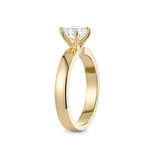 Load image into Gallery viewer, Stunning solitaire engagement ring in 18K yellow gold, weighing approximately 4.75gr, featuring a dazzling 1.06ct round brilliant diamond in a six claw setting on a wide tapering band.
