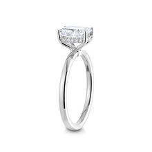 Load image into Gallery viewer, Stunning engagement ring in 18K white gold, featuring a 2ct radiant cut diamond, held high above a slim 1.8mm band with a hidden halo of small pavé diamonds.
