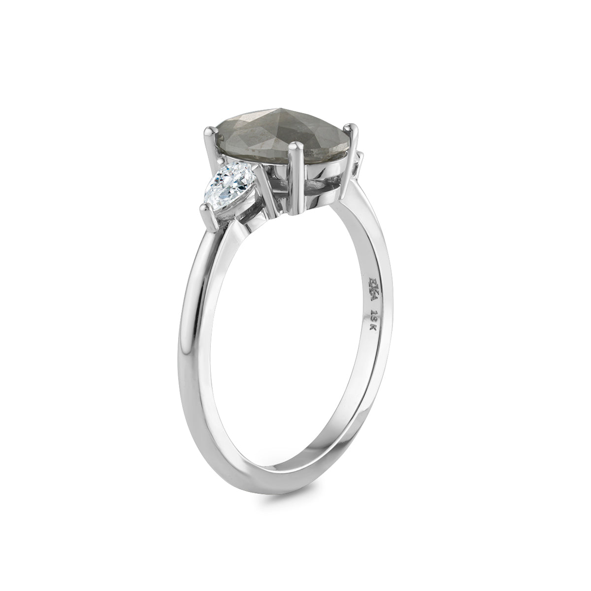  This unique engagement ring combines traditional and modern elements, featuring a 1.59ct oval salt & pepper diamond from the grey diamond family. It's accented by two pear-shaped diamonds totaling 0.32ct each, set in 18K white gold.