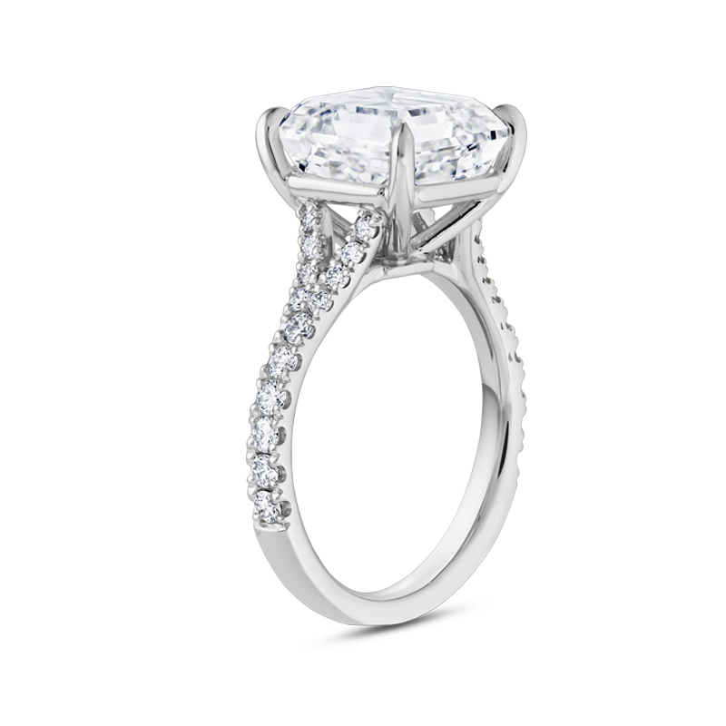 Exquisite platinum engagement ring featuring a 5ct Asscher cut lab diamond, VS1/F, in an eagle claw setting, with a split band and cathedral style silhouette, adorned with 0.39tcw of small round brilliant diamonds pavé set along the band, offering classic styling with Deco glamour.