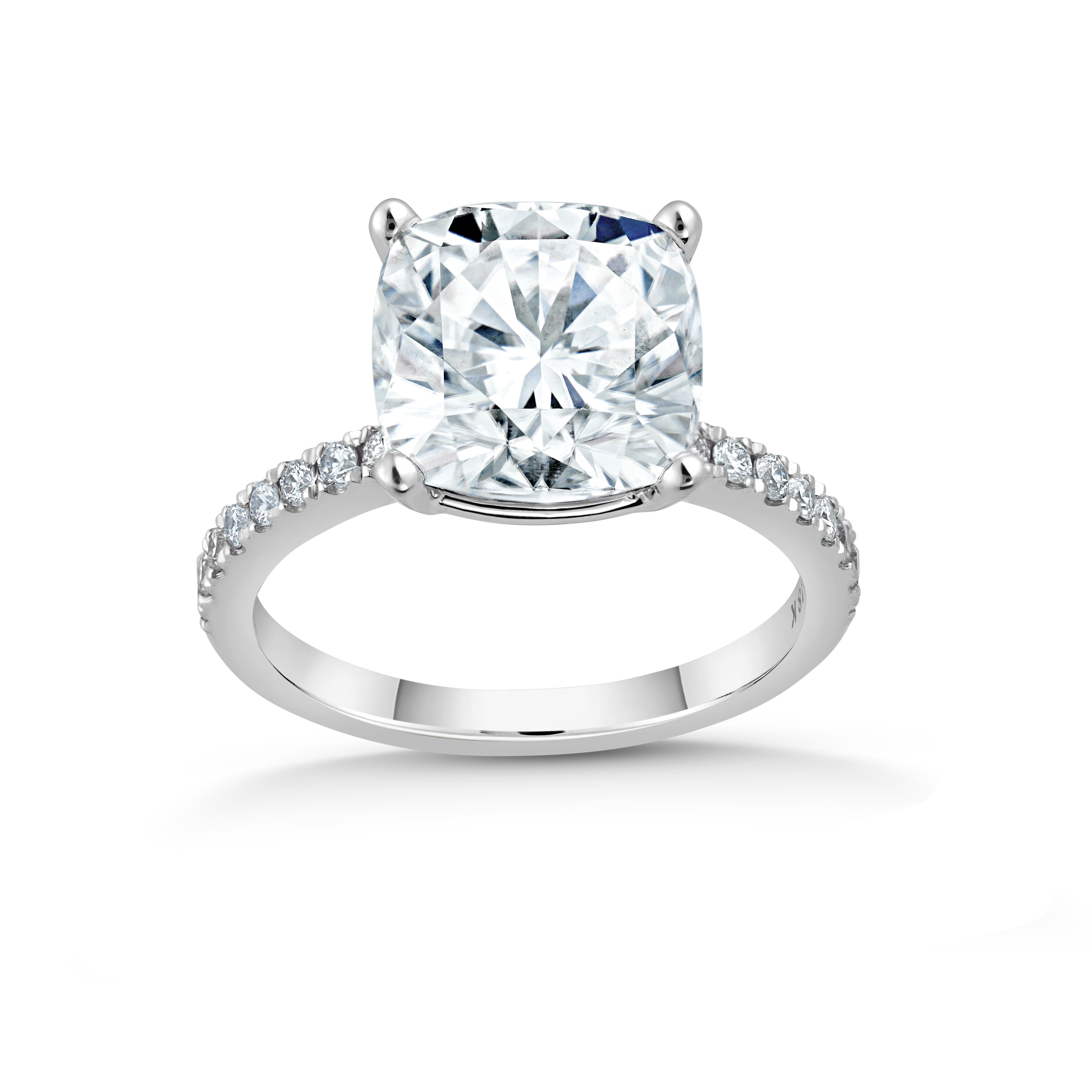 Exquisite engagement ring in 18K white gold, featuring a 3.18ct cushion cut diamond in a four-claw setting, complemented by 0.23tcw of small pavé set diamonds on the band, crafted to harmonize with various band styles.