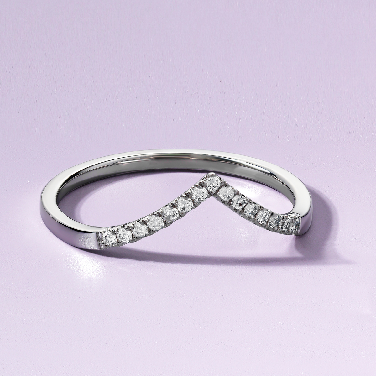 Retro-inspired 18K white gold chevron-shaped band, handcrafted in Montreal by Ex Aurum, featuring approximately 0.10tcw with 15 round brilliant diamonds in a pavé setting.