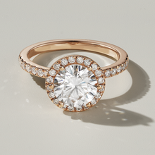 Load image into Gallery viewer, Luxurious engagement ring in 18K rose gold, weighing approximately 3.80gr, featuring a 1.5ct Moissanite center surrounded by a halo and 0.40tcw of 36 shimmering diamonds.
