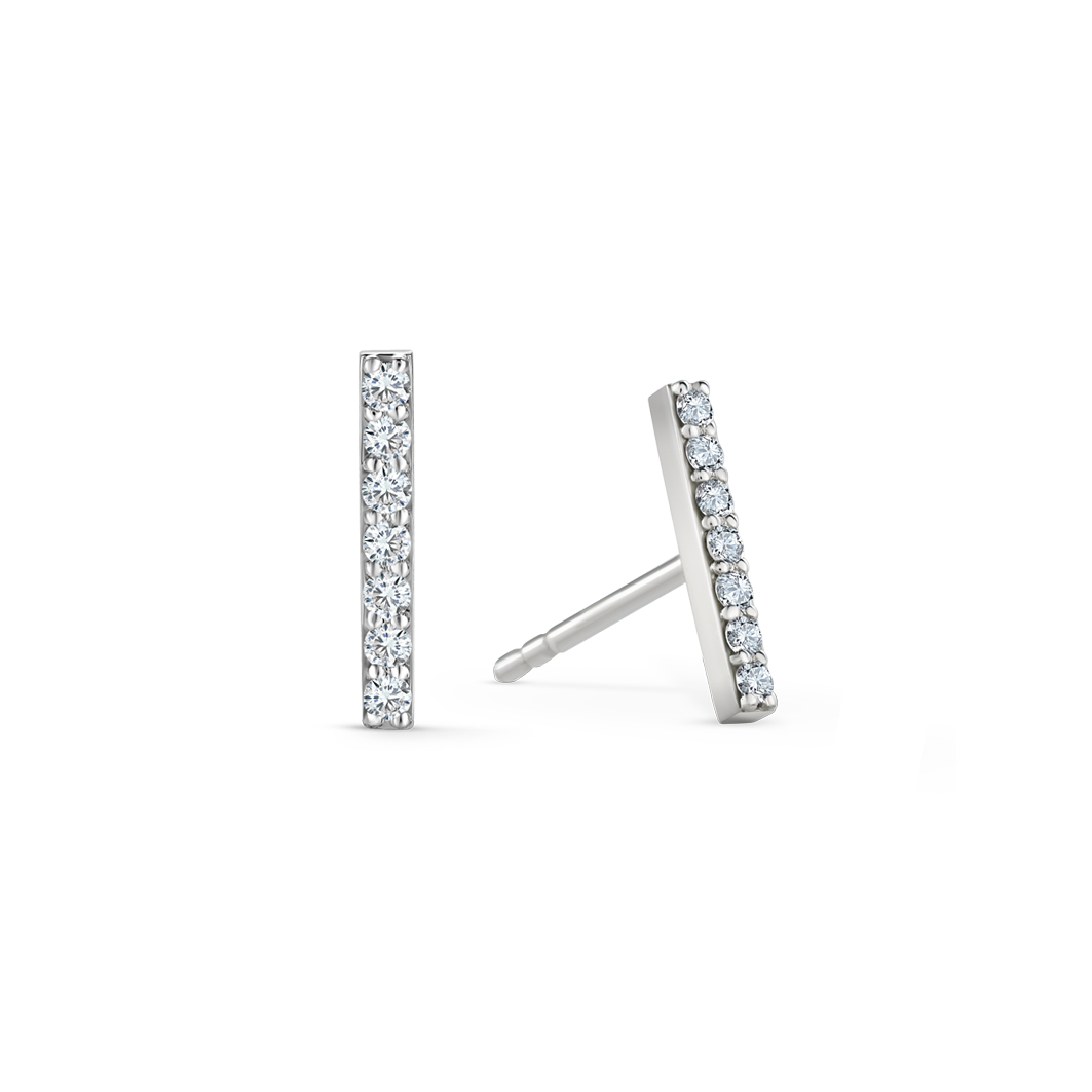 Elegant earrings in 18K white gold, each featuring seven round brilliant diamonds totaling approximately 0.140tcw in a sleek bar design, offering a delicate yet impactful geometric style.