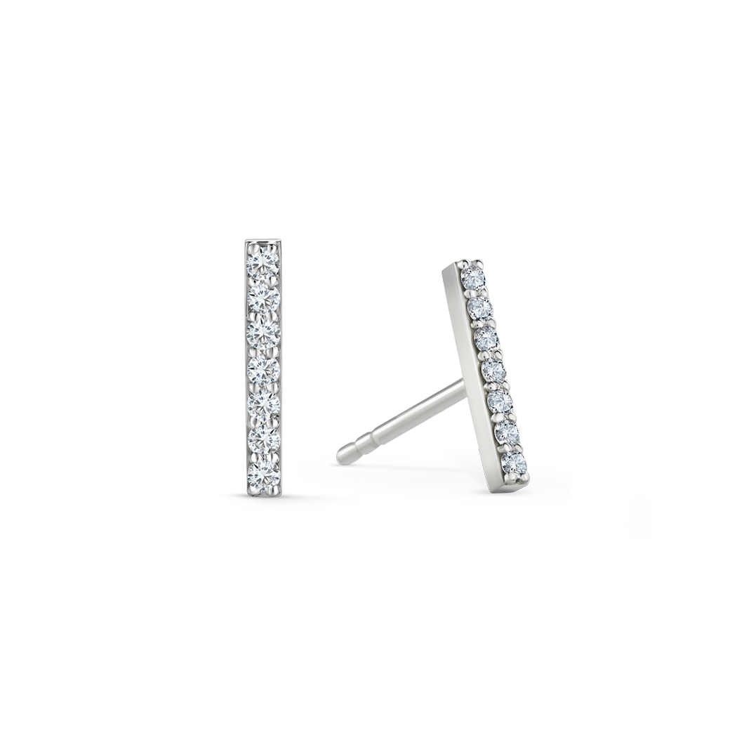 Elegant earrings in 18K white gold, each featuring seven round brilliant diamonds totaling approximately 0.140tcw in a sleek bar design, offering a delicate yet impactful geometric style.