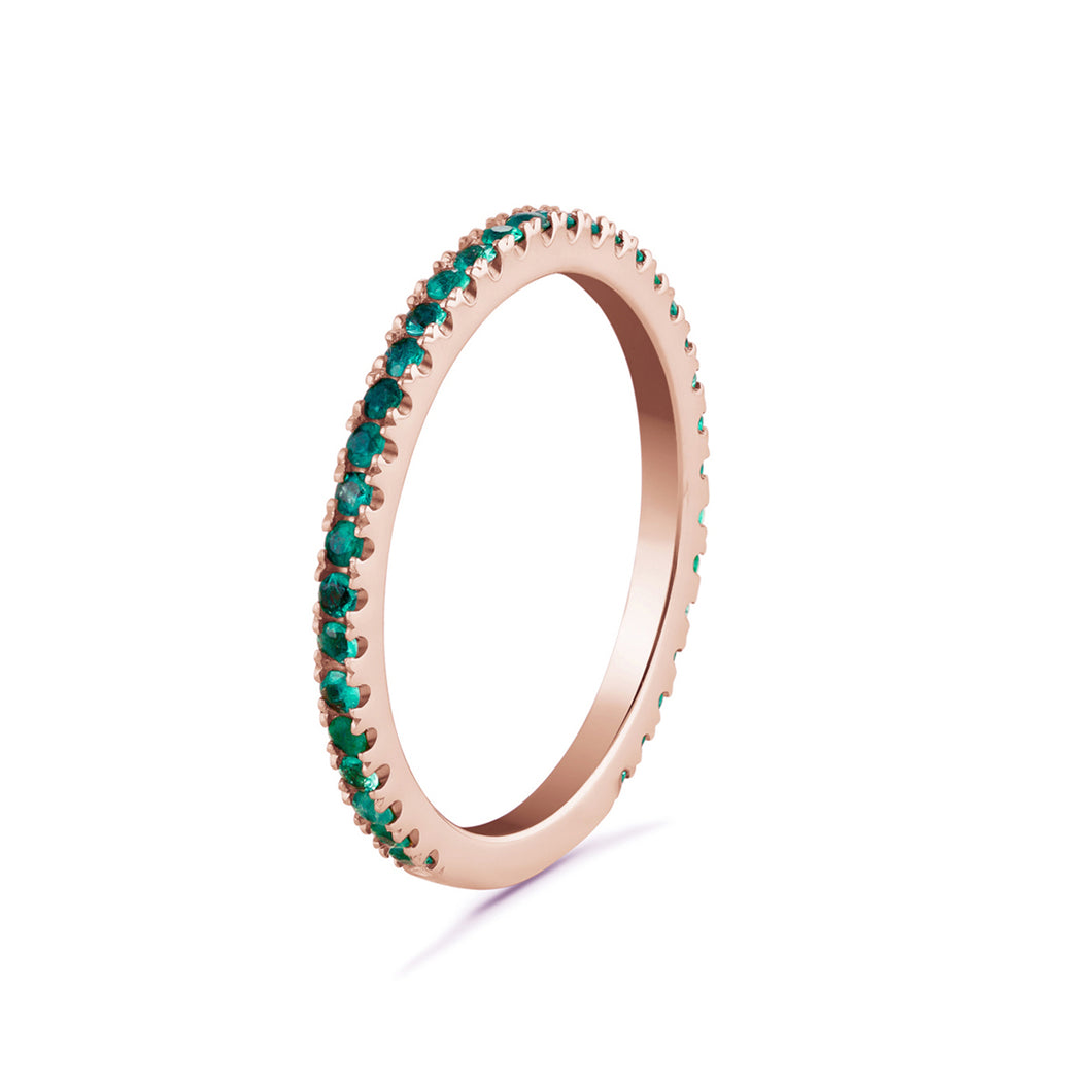 Stunning 14K rose gold 'Emerald Ambrosia' eternity band, featuring 0.27tcw of vibrant round emeralds, symbolizing eternal love and commitment, perfect for adding a touch of color and radiance.