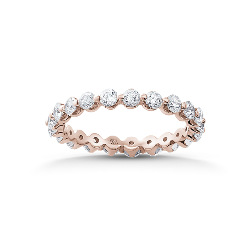 Exquisite 18K rose gold band featuring 1.05tcw round brilliant diamonds in a shared prong setting, with circular openings inside for comfort, showcasing a rhythmic and light design, handcrafted by Ex Aurum in Montreal.