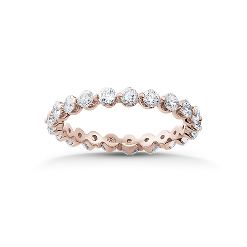 Exquisite 18K rose gold band featuring 1.05tcw round brilliant diamonds in a shared prong setting, with circular openings inside for comfort, showcasing a rhythmic and light design, handcrafted by Ex Aurum in Montreal.