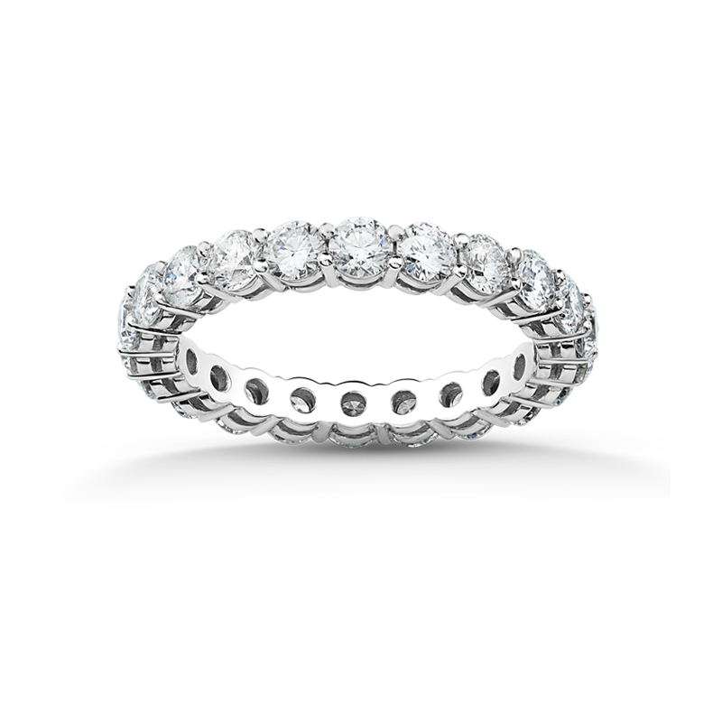 Stunning full eternity ring in 18K white gold, approximately 2.5gr, adorned with 1.44tcw of round brilliant diamonds in a four-claw setting, featuring a geometric open circle pattern on the interior.