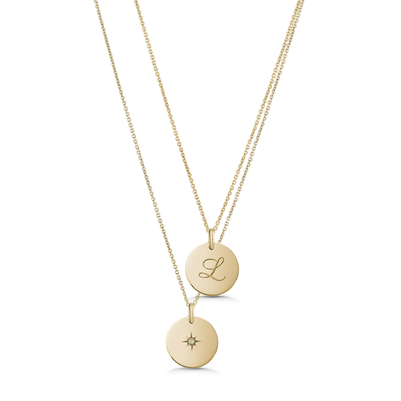 Unique double-sided 14K yellow gold pendant, featuring a script-styled initial on one side and a gemstone set in a diamond-cut star pattern on the reverse, measuring 15mm in diameter, accompanied by an 18" adjustable chain.