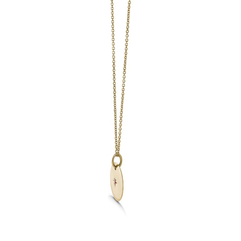 Unique double-sided 14K yellow gold pendant, featuring a script-styled initial on one side and a gemstone set in a diamond-cut star pattern on the reverse, measuring 15mm in diameter, accompanied by an 18" adjustable chain.