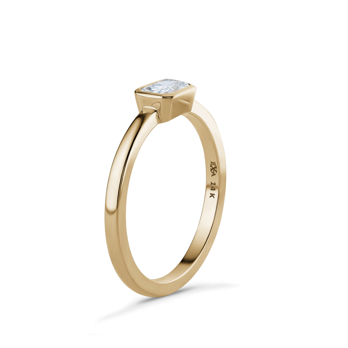 Elegant Radiant Sunbeam gold ring in 14K yellow gold, featuring a 0.31ct radiant cut diamond in a modern bezel setting, combining the rich warmth of the gold band with the dazzling sparkle of the diamond.