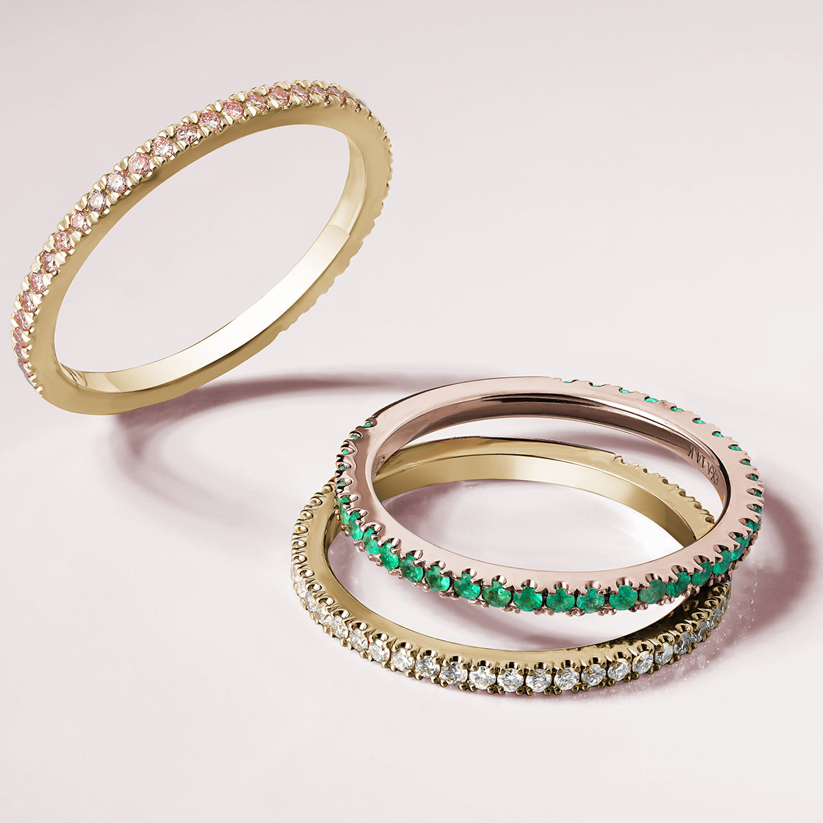 14K rose gold eternity band, adorned with 0.27tcw of vibrant round emeralds, representing eternal love and commitment, perfect for adding a touch of color and brilliance.