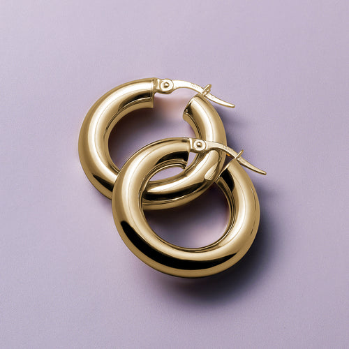 Elegant 10K yellow gold hoop earrings, 25mm in diameter with a 5mm tube width, featuring a high polished glossy finish, offering a luxurious and warm appearance, Italian-made for refined comfort.