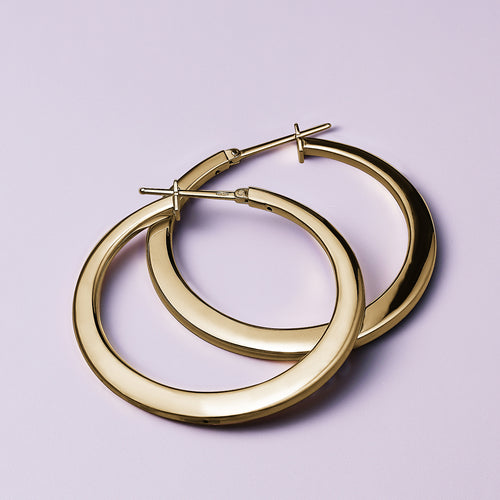 Elegant 18K yellow gold tapering hoop earrings, featuring a unique rounded to flattish silhouette with a 38mm diameter, combining timeless style with a contemporary design.