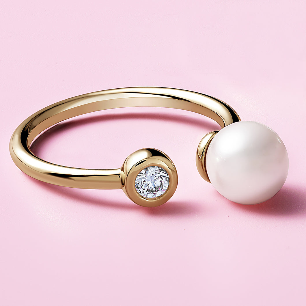 Elegant ring in 14K yellow gold, handcrafted by Ex Aurum in Montreal, featuring a 6.5-6.75mm round white pearl and a 0.09ct round brilliant diamond in a bezel setting, symbolizing purity and unity.