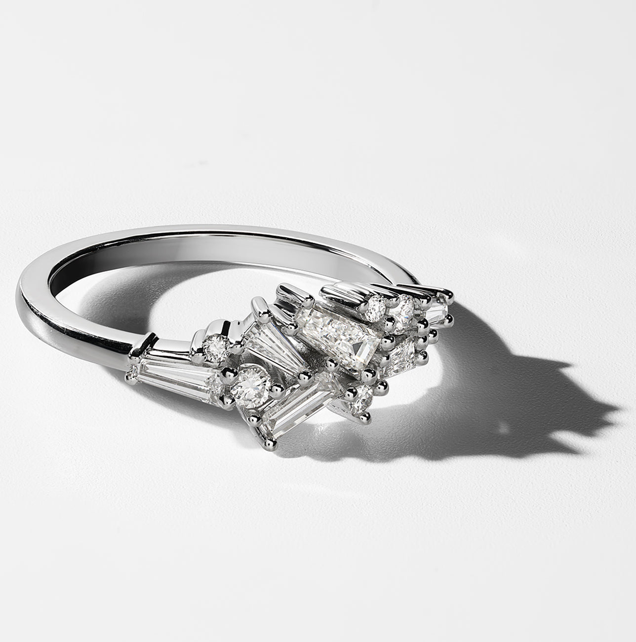  This 18K white gold ring features a unique arrangement of baguette and round brilliant diamonds, totaling 0.55ct for the baguettes and 0.11ct for the seven diamonds, set in a claw setting, offering an exquisite and captivating design.