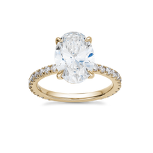 Load image into Gallery viewer, Luxurious engagement ring in 18K yellow gold, featuring a 3.09ct oval lab diamond (VS1 H) with a hidden pavé diamond halo and 0.55tcw of small round diamonds along the band, offering a blend of simplicity and detailed elegance.
