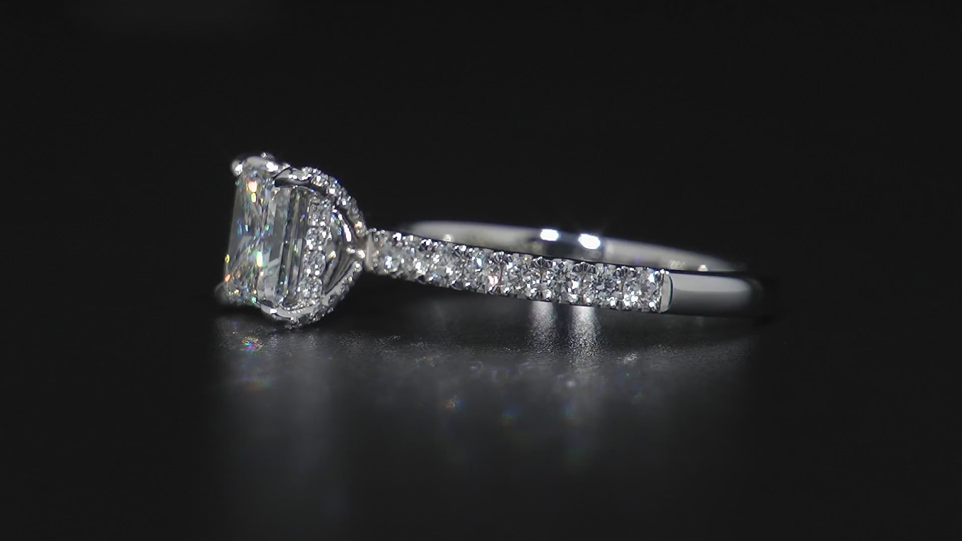 Solitaire engagement ring in 18K white gold, featuring a 1.20ct princess cut diamond with fine pavé set diamonds on the prongs and a hidden halo, totaling 0.47tcw, offering a blend of strong elegance and subtle details.