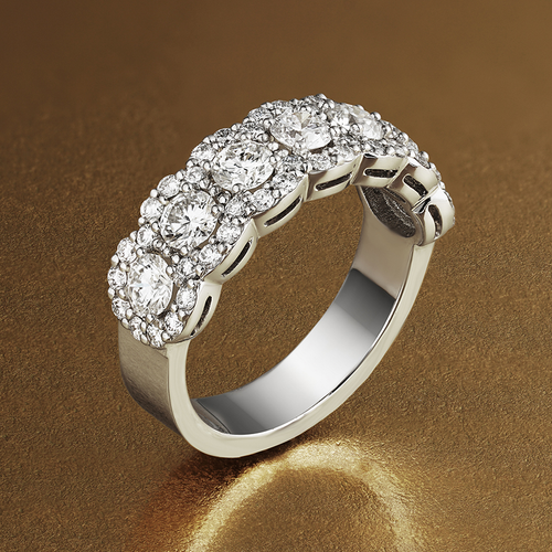 Exquisite ring in 18K white gold, handcrafted in Montreal by Ex Aurum, featuring seven feature diamonds surrounded by a continuous scalloped halo, with a total of approximately 53 diamonds and weighing about 5gr, showcasing a gleaming and elegant design.