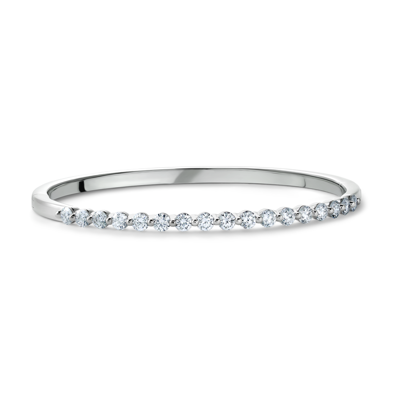 Elegant 18K white gold bangle featuring 17 round brilliant diamonds totaling approximately 1.19ctw, set in a shared prong technique for a contemporary and airy design, creating a dazzling effect.