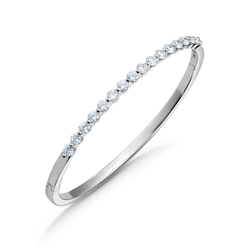 Elegant 18K white gold bangle featuring 17 round brilliant diamonds totaling approximately 1.19ctw, set in a shared prong technique for a contemporary and airy design, creating a dazzling effect.