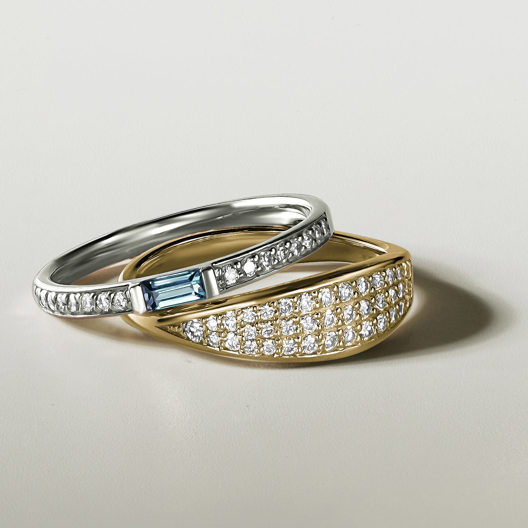 Elegant ring in 14K white gold, handcrafted by Ex Aurum in Montreal, featuring a soft sky-blue topaz baguette center with 0.13ctw diamond pavé along the sides, creating a refreshing and colorful touch.