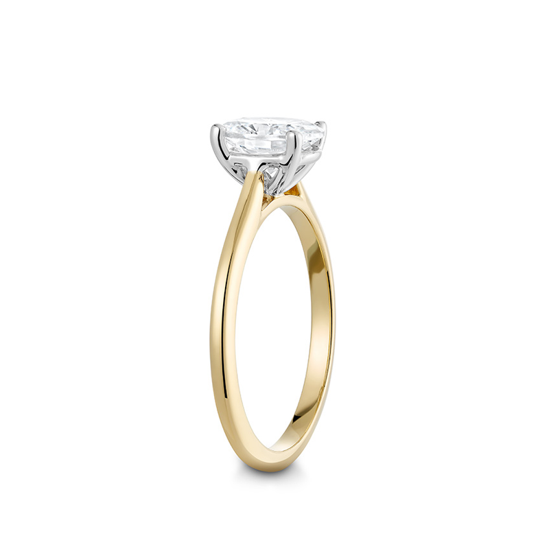 Elegant engagement ring in 18K yellow gold with a white gold setting, featuring a 1ct oval diamond in a four claw setting, designed to elongate the hand.