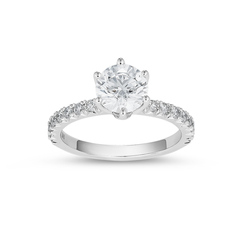 Stunning 18K white gold solitaire ring, featuring a 1.20ct round brilliant VS1 D diamond in a six-claw setting, with a flame-shaped design and 0.36tcw pavé set diamonds along three-quarters of the slim band.