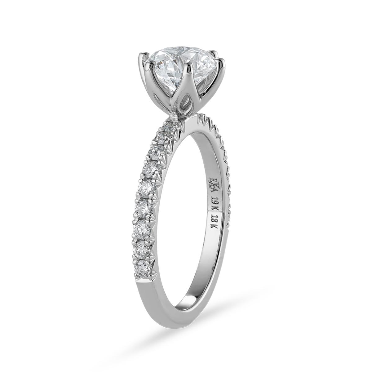 Stunning 18K white gold solitaire ring, featuring a 1.20ct round brilliant VS1 D diamond in a six-claw setting, with a flame-shaped design and 0.36tcw pavé set diamonds along three-quarters of the slim band.