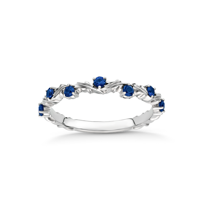 Elegant band in 18K white gold, featuring a meandering design with 0.17ctw of sapphires in fine prong settings, offering a natural and colorful aesthetic that complements other rings.