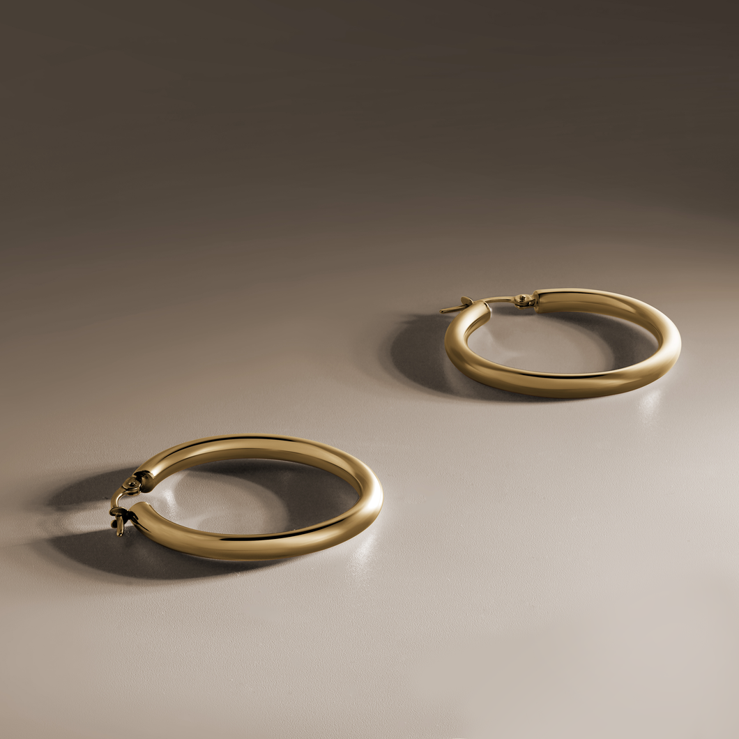 Classic Italian 18K yellow gold hoop earrings, 31mm in diameter with 3mm round tubes, featuring a curved tension post for secure wear, combining all-day comfort with a glossy, impactful look.