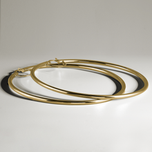 Charger l&#39;image dans la galerie, 18K yellow gold hoop earrings, measuring approximately 72mm in diameter with a 2.5mm tube, designed for all-day comfort and a strong shape, crafted with Italian elegance.
