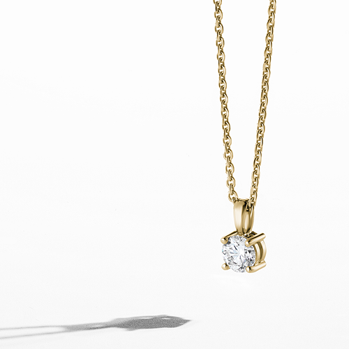 18K yellow gold pendant featuring a gracefully tapering bail and a claw-set round brilliant diamond of about .42ct, on a 17
