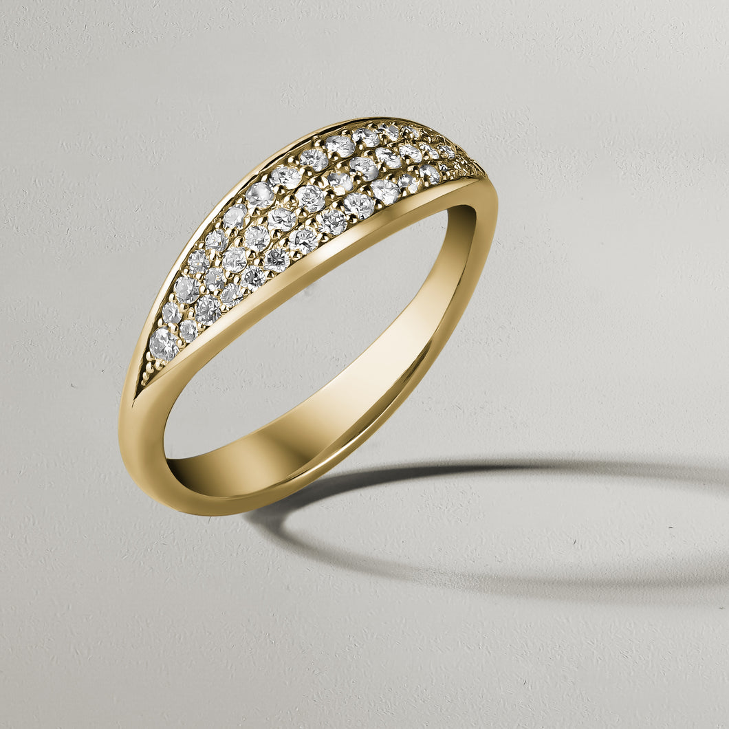 Elegant sculpted 18K yellow gold ring, resembling a slow wave, adorned with approximately 0.35ct of pavé set diamonds.