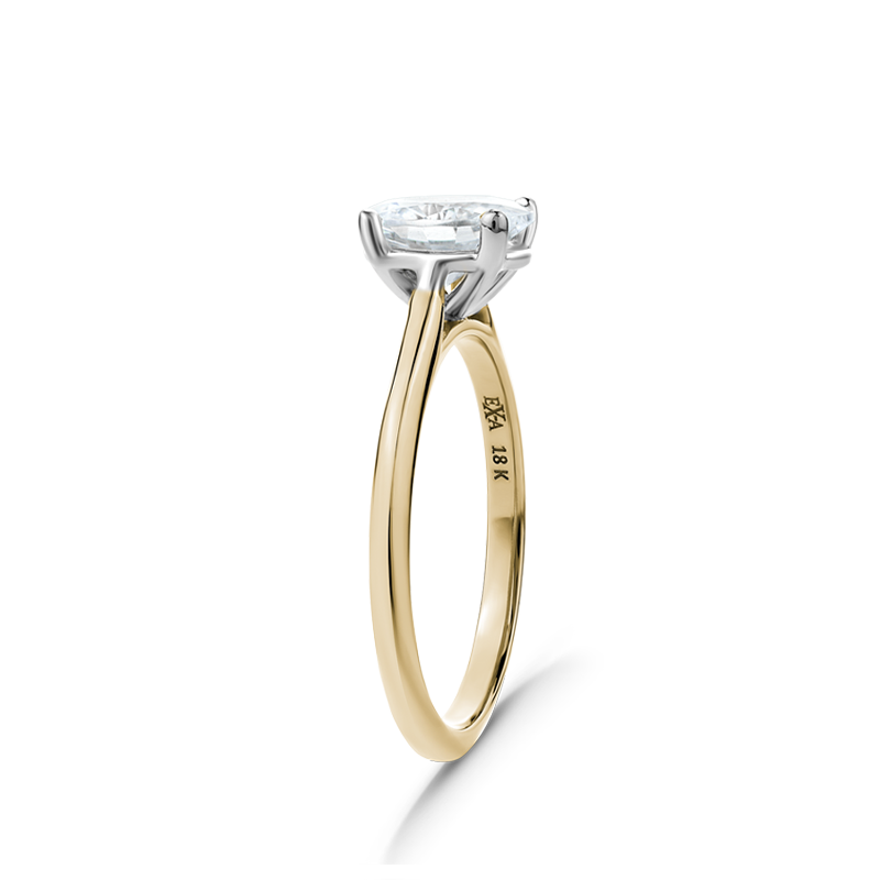 Elegant engagement ring in 18K yellow gold with a white gold setting, featuring a 1ct oval diamond in a four claw setting, designed to elongate the hand.