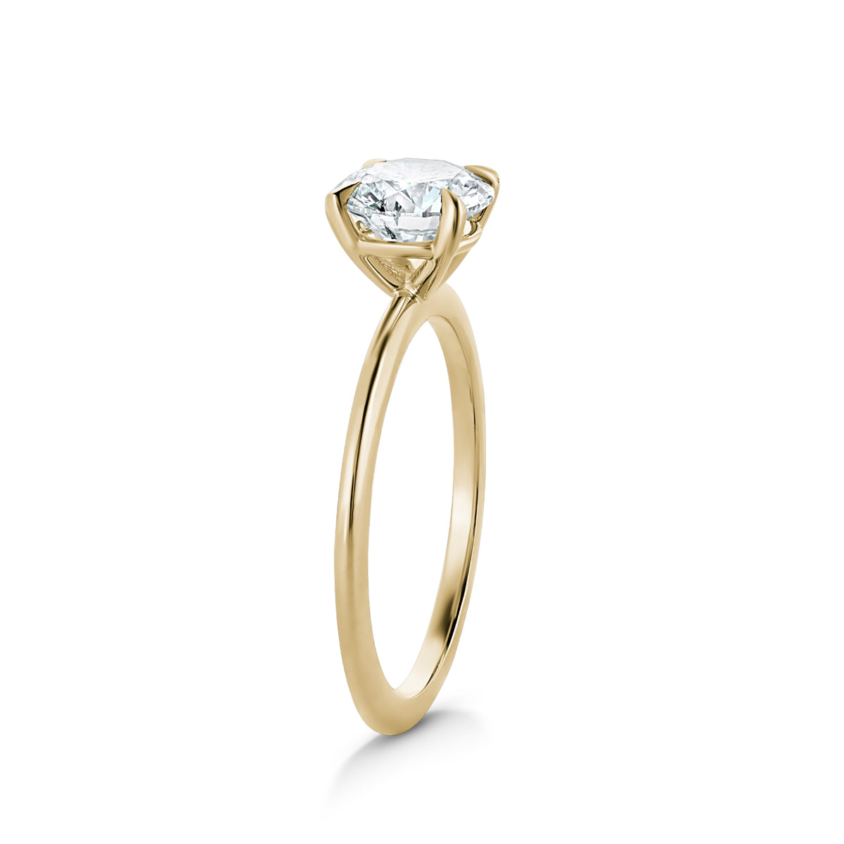 Delicate 'Fine Spirit' solitaire engagement ring in 14K yellow gold, featuring a 1.01ct lab diamond on a slim 1.6mm band with a reverse taper and finely pointed claws, embodying minimalist elegance.